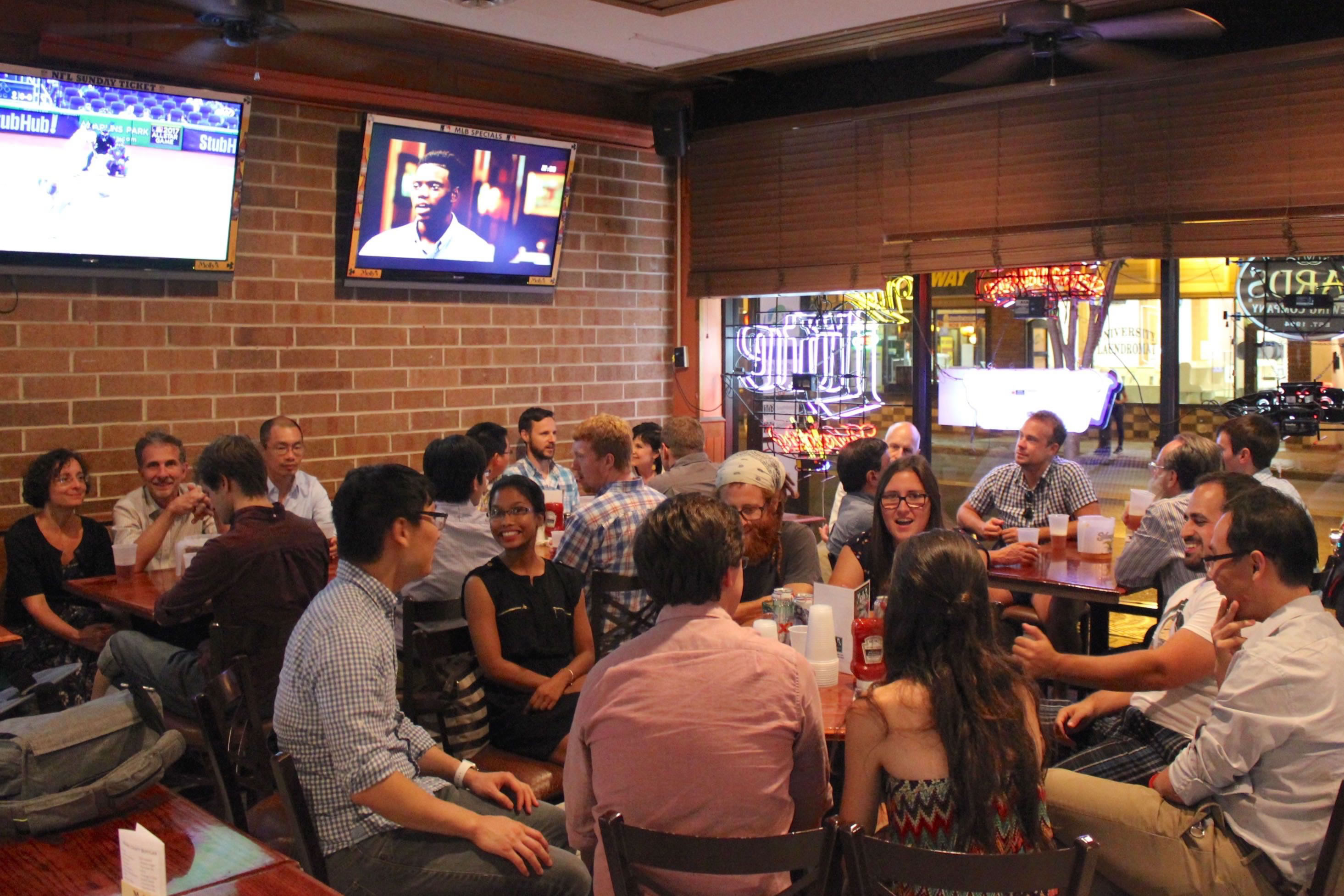Attendees meet at a bar