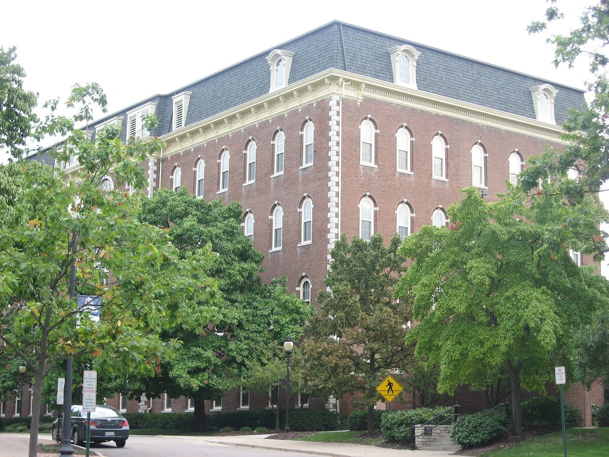 St. Mary's Hall, a five-storey red-brick building with a mansard roof, framed by trees